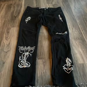 Black broken promises skinny jeans with white graphic, size 32, good condition.